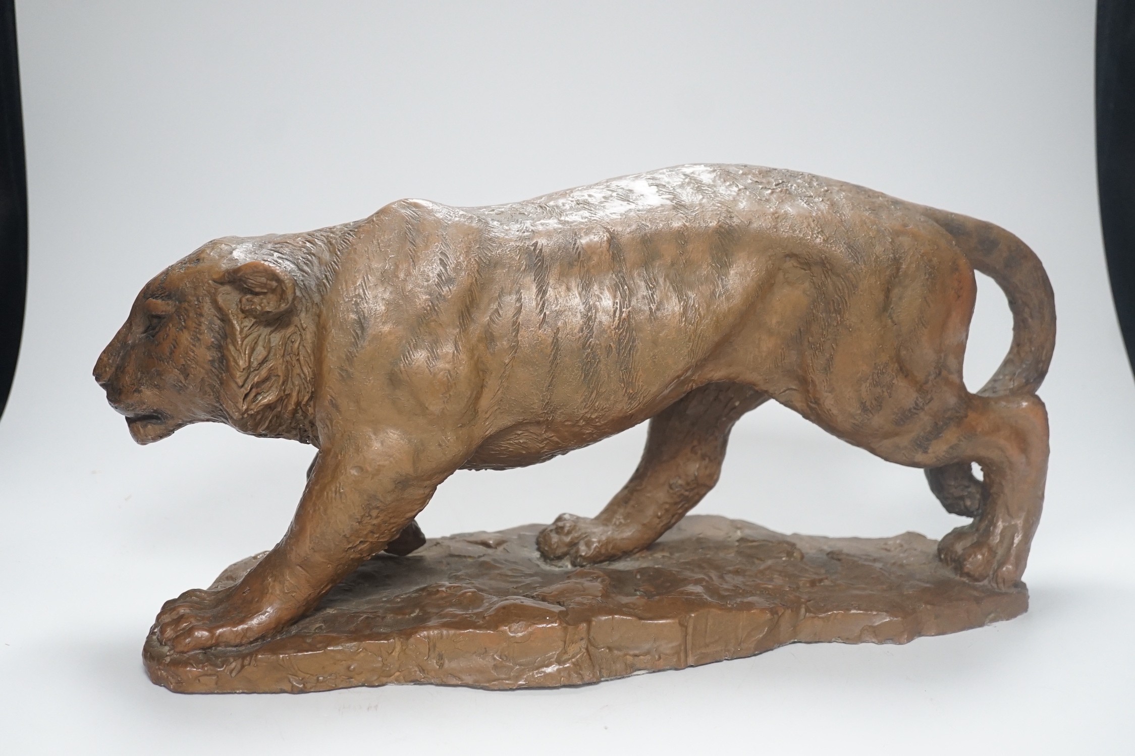 A cold cast resin bronze model of a prowling tiger, 45cm long